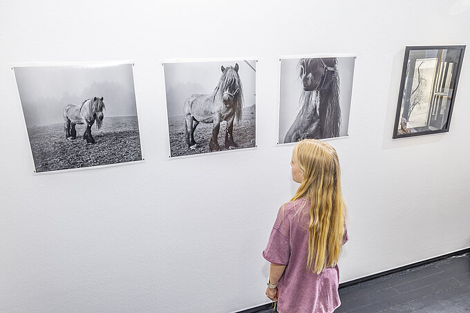 View of the exhibition with a visitor (opens enlarged image)